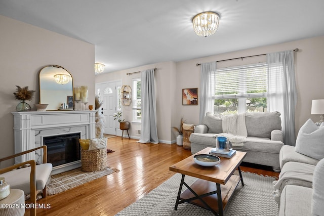 33 Red Maple Dr, Brick, NJ 08724 - living room featuring a chandelier, light wood-style flooring, plenty of natural light, and a glass covered fireplace