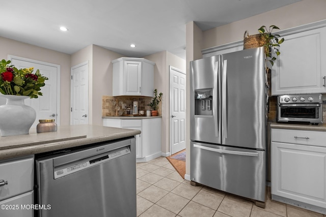 33 Red Maple Dr, Brick, NJ 08724 - kitchen featuring appliances with stainless steel finishes, white cabinetry, light tile patterned floors, recessed lighting, and backsplash
