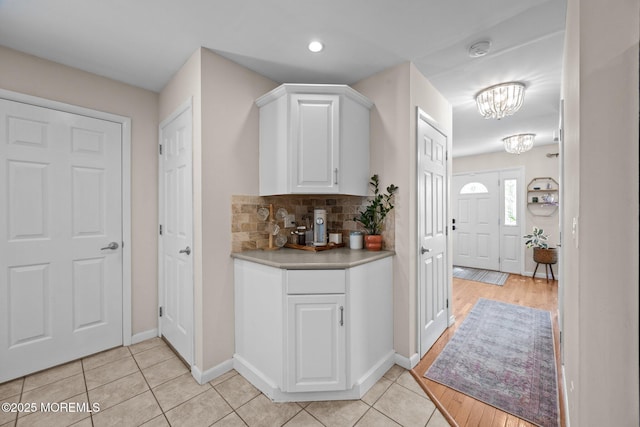 33 Red Maple Dr, Brick, NJ 08724 - bar area featuring a chandelier, light tile patterned floors, backsplash, and baseboards