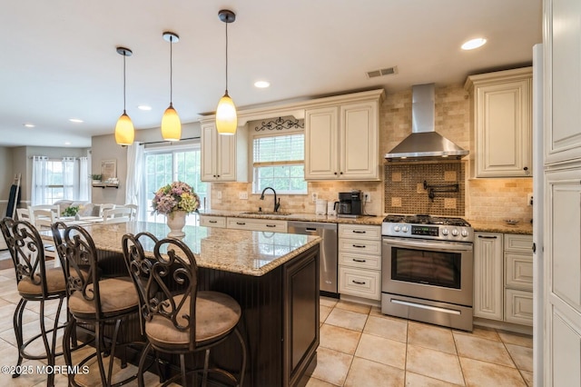 81 W Shenendoah Rd, Howell, NJ 07731 - kitchen with stainless steel appliances, wall chimney exhaust hood, a sink, cream cabinets, and recessed lighting