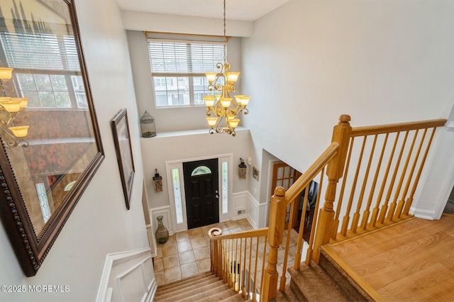 81 W Shenendoah Rd, Howell, NJ 07731 - tiled entrance foyer featuring a chandelier, a decorative wall, wainscoting, and stairway