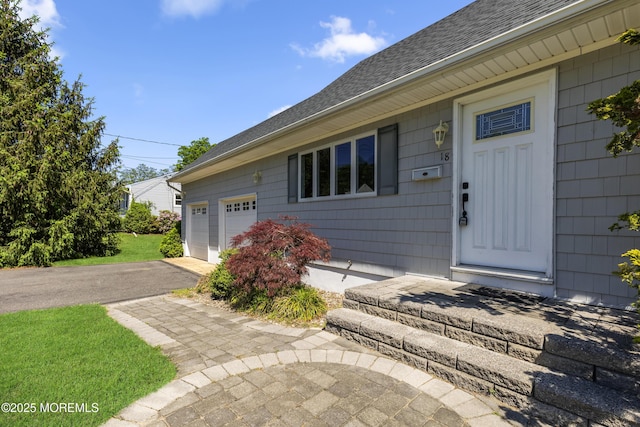 18 Hampton Rd, Howell, NJ 07731 - view of exterior entry with roof with shingles and asphalt driveway