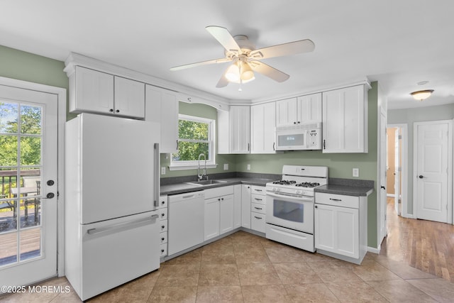 18 Hampton Rd, Howell, NJ 07731 - kitchen featuring white appliances, a sink, dark countertops, and white cabinetry