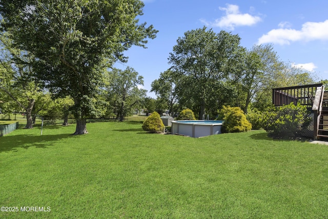18 Hampton Rd, Howell, NJ 07731 - view of grassy yard featuring an outdoor pool, stairway, and a wooden deck