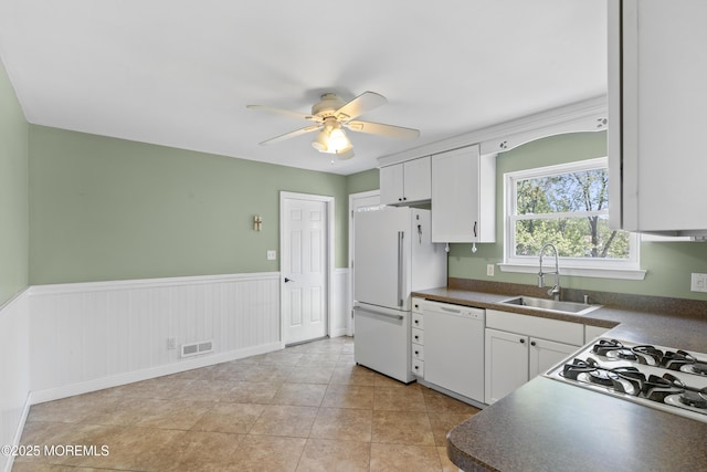 18 Hampton Rd, Howell, NJ 07731 - kitchen with white appliances, a sink, dark countertops, a ceiling fan, and wainscoting