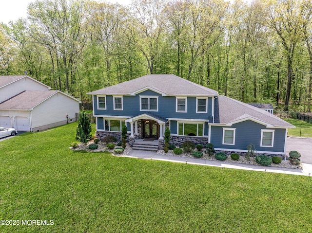25 Briar Hill Dr, Manalapan, NJ 07726 - view of front of house featuring covered porch, stone siding, a front yard, and a shingled roof
