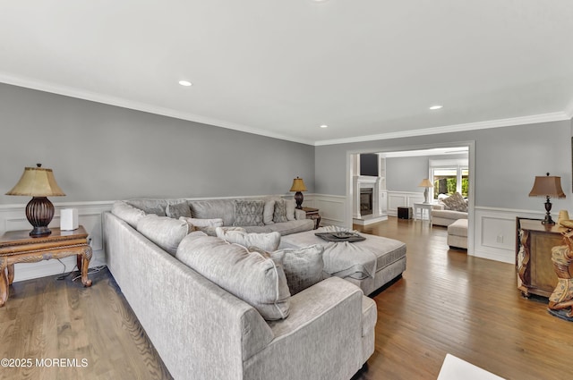 25 Briar Hill Dr, Manalapan, NJ 07726 - living room with wood finished floors, a wainscoted wall, ornamental molding, recessed lighting, and a decorative wall
