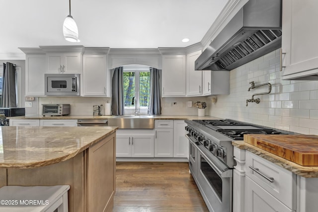 25 Briar Hill Dr, Manalapan, NJ 07726 - kitchen with stainless steel appliances, wall chimney range hood, tasteful backsplash, a sink, and dark wood-type flooring