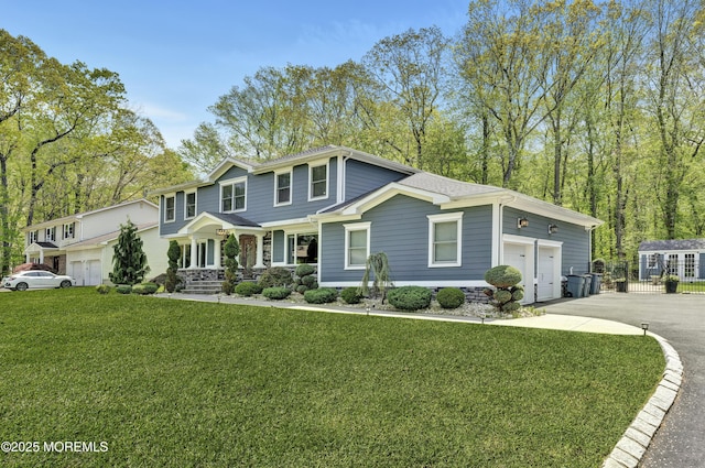 25 Briar Hill Dr, Manalapan, NJ 07726 - view of front of house with asphalt driveway, covered porch, and a front lawn