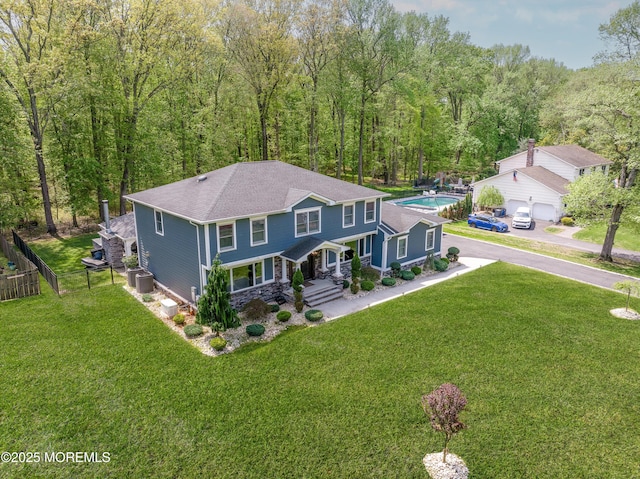 25 Briar Hill Dr, Manalapan, NJ 07726 - view of front facade featuring covered porch, stone siding, a shingled roof, a forest view, and a garage