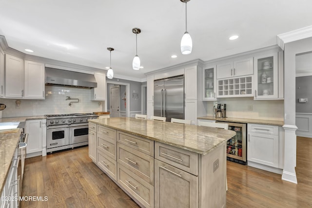 25 Briar Hill Dr, Manalapan, NJ 07726 - kitchen featuring high quality appliances, wall chimney range hood, beverage cooler, decorative backsplash, and ornamental molding