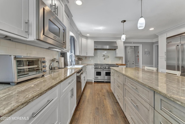 25 Briar Hill Dr, Manalapan, NJ 07726 - kitchen featuring built in appliances, wall chimney range hood, backsplash, dark wood finished floors, and ornamental molding