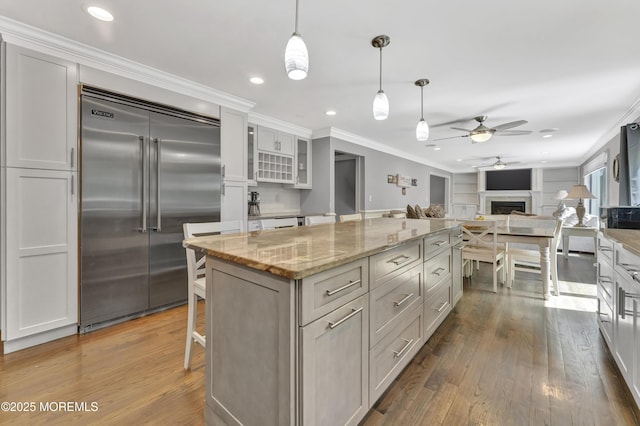 25 Briar Hill Dr, Manalapan, NJ 07726 - kitchen with stainless steel built in fridge, ceiling fan, hardwood / wood-style floors, crown molding, and a center island
