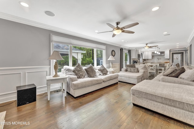 25 Briar Hill Dr, Manalapan, NJ 07726 - living area featuring crown molding, a ceiling fan, a decorative wall, wood finished floors, and recessed lighting