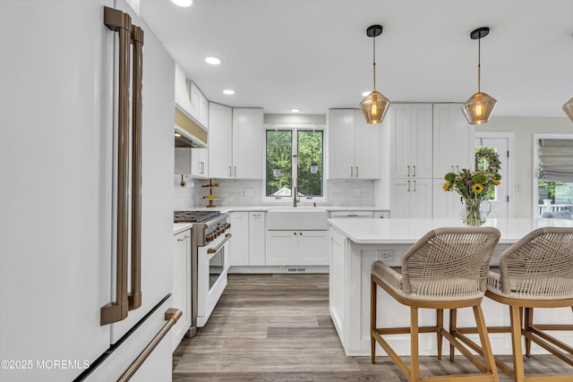 25 Glenview Rd, North Caldwell, NJ 07006 - kitchen featuring freestanding refrigerator, range with gas cooktop, a sink, light countertops, and dark wood finished floors