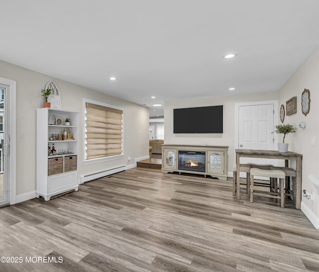 25 Glenview Rd, North Caldwell, NJ 07006 - living area with a baseboard heating unit, a glass covered fireplace, wood finished floors, recessed lighting, and baseboards