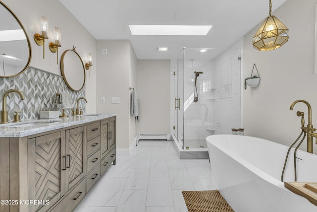 25 Glenview Rd, North Caldwell, NJ 07006 - bathroom featuring marble look tiles, baseboard heating, a freestanding bath, a skylight, and double vanity