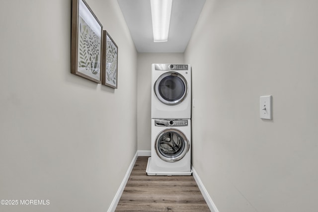 25 Glenview Rd, North Caldwell, NJ 07006 - laundry room featuring stacked washer / dryer, wood finished floors, and baseboards