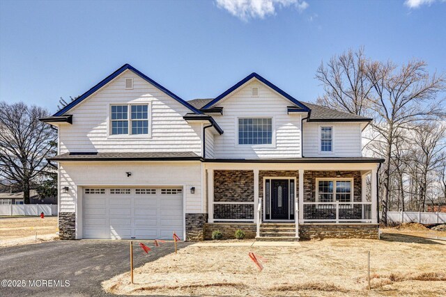 97D Aberdeen Rd, Matawan, NJ 07747 - view of front facade with asphalt driveway, stone siding, an attached garage, and covered porch