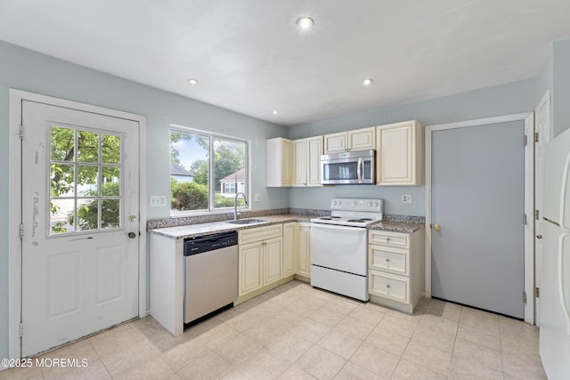 731A Chatham Ln, Manchester, NJ 08759 - kitchen featuring stainless steel appliances, a sink, cream cabinets, recessed lighting, and light stone countertops