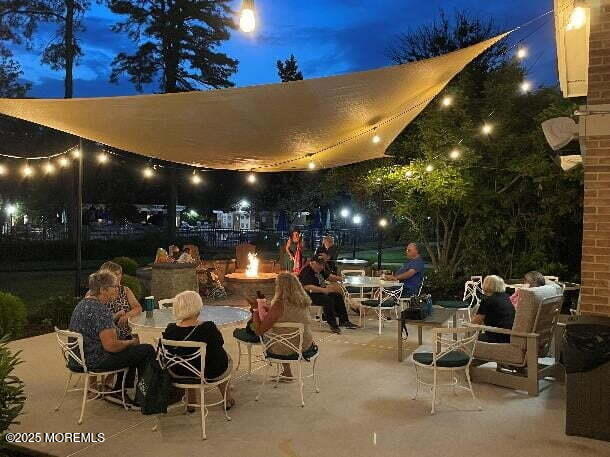 731A Chatham Ln, Manchester, NJ 08759 - patio at twilight with an outdoor fire pit, a patio area, and outdoor dining area