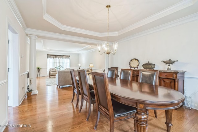 5 Duke Dr, Howell, NJ 07731 - dining room with a raised ceiling, ornate columns, ornamental molding, light wood-type flooring, and a chandelier