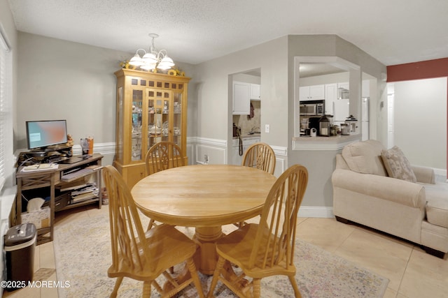 104 Deerfoot Way, Jackson, NJ 08527 - dining area with a chandelier, light tile patterned flooring, wainscoting, and a textured ceiling