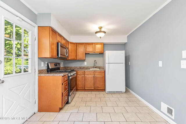 7 Beechwood Ave, Keansburg, NJ 07734 - kitchen featuring stainless steel appliances, a sink, healthy amount of natural light, and brown cabinetry