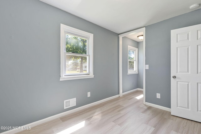 7 Beechwood Ave, Keansburg, NJ 07734 - unfurnished bedroom with multiple windows, baseboards, and light wood-style floors