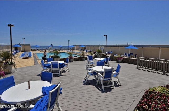 787 Ocean Ave Unit 1711, Long Branch, NJ 07740 - wooden terrace featuring outdoor dining area and a community pool