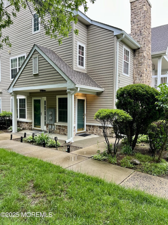 5 Lincoln Ct, Tinton Falls, NJ 07712 - view of property featuring a shingled roof, a chimney, and covered porch