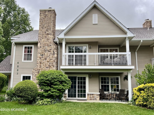 5 Lincoln Ct, Tinton Falls, NJ 07712 - rear view of property featuring a balcony, a chimney, stone siding, a shingled roof, and a patio