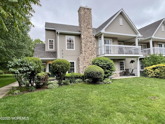 5 Lincoln Ct, Tinton Falls, NJ 07712 - back of property with a balcony, a chimney, a lawn, a patio area, and roof with shingles