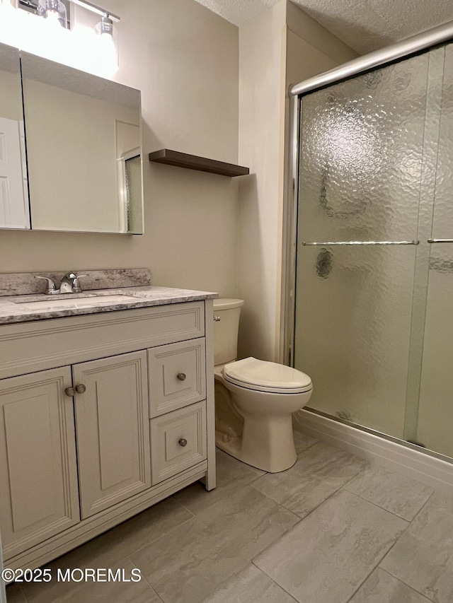 5 Lincoln Ct, Tinton Falls, NJ 07712 - bathroom featuring toilet, vanity, a stall shower, and a textured ceiling