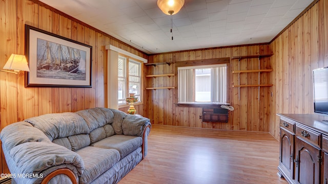 116 Hudson Ave, Hazlet, NJ 07734 - living room featuring healthy amount of natural light, ornamental molding, wooden walls, light wood-style floors, and baseboards