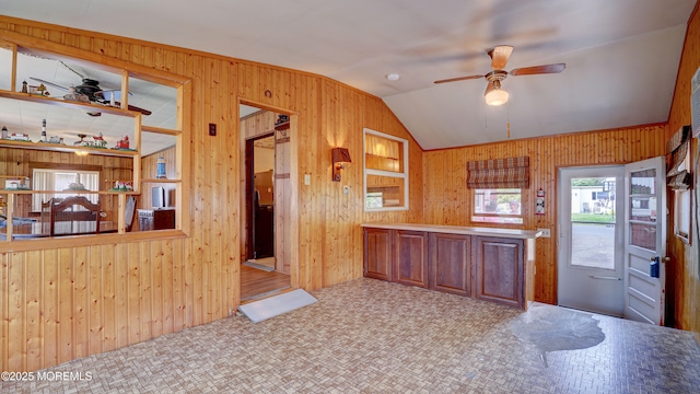 116 Hudson Ave, Hazlet, NJ 07734 - kitchen with wood walls, ceiling fan, lofted ceiling, and tile patterned floors