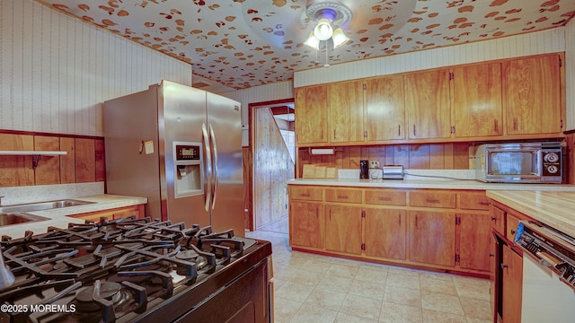 116 Hudson Ave, Hazlet, NJ 07734 - kitchen featuring wallpapered walls, stainless steel fridge with ice dispenser, gas range oven, dishwasher, and light countertops