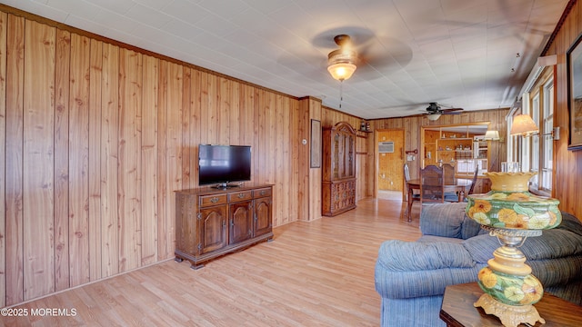 116 Hudson Ave, Hazlet, NJ 07734 - living room with wood walls, light wood-style floors, and a ceiling fan