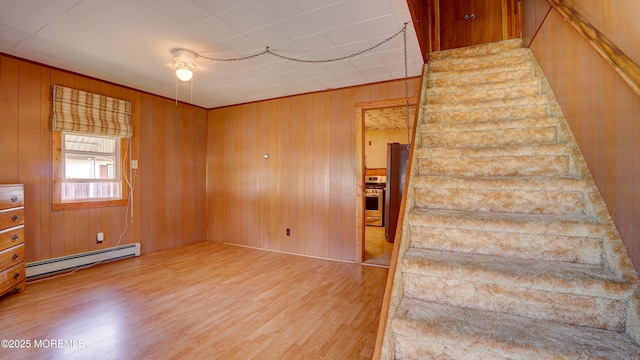 116 Hudson Ave, Hazlet, NJ 07734 - stairs featuring a baseboard heating unit, wood finished floors, and wooden walls
