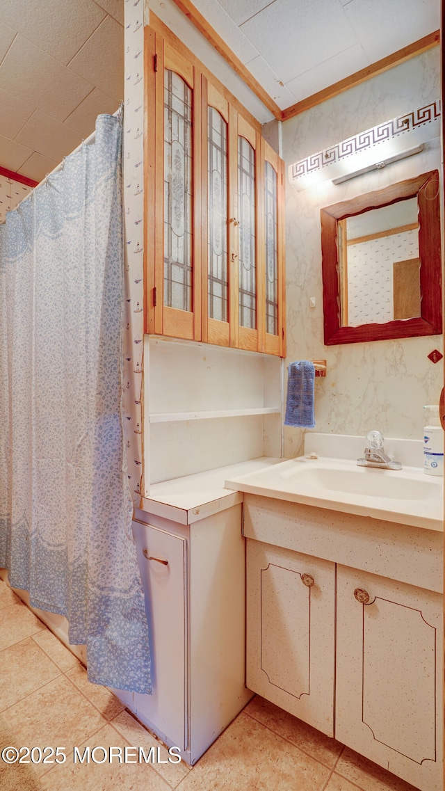 116 Hudson Ave, Hazlet, NJ 07734 - bathroom with vanity, tile patterned floors, wallpapered walls, a shower with shower curtain, and ornamental molding