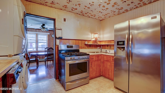 116 Hudson Ave, Hazlet, NJ 07734 - kitchen featuring stainless steel appliances, stacked washer / drying machine, wallpapered walls, a sink, and light countertops