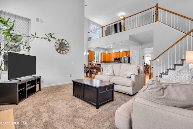 34 Shoal Rd, Jackson, NJ 08527 - living area featuring a high ceiling, stairs, light colored carpet, and baseboards