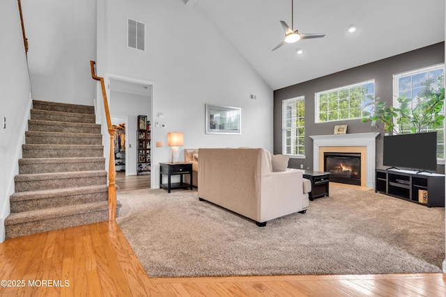 34 Shoal Rd, Jackson, NJ 08527 - living room with high vaulted ceiling, stairs, light wood finished floors, ceiling fan, and a fireplace with flush hearth
