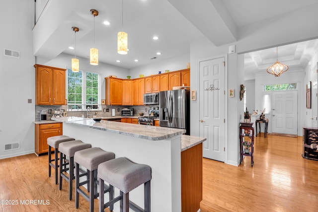 34 Shoal Rd, Jackson, NJ 08527 - kitchen featuring appliances with stainless steel finishes, light wood-type flooring, a kitchen island, recessed lighting, and decorative backsplash