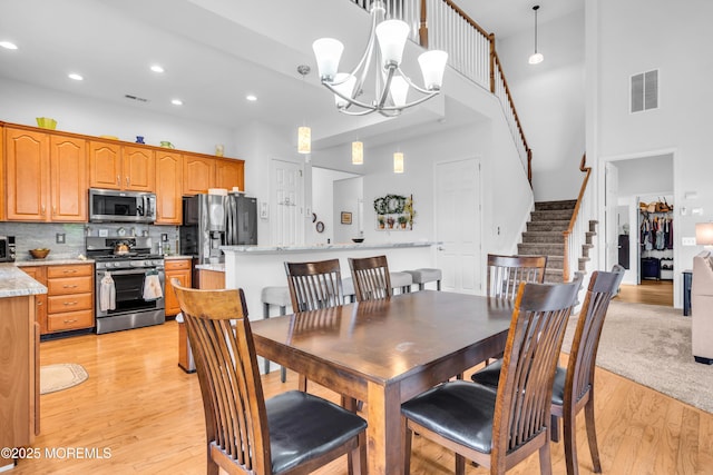 34 Shoal Rd, Jackson, NJ 08527 - dining space featuring a high ceiling, light wood finished floors, stairway, a chandelier, and recessed lighting