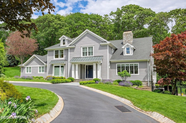 12 Wagon Way, Holmdel, NJ 07733 - view of front of house featuring a front lawn, a chimney, a shingled roof, and asphalt driveway