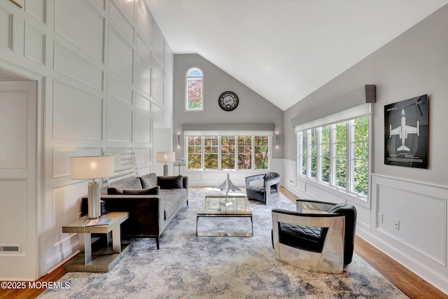 12 Wagon Way, Holmdel, NJ 07733 - living room with a decorative wall, wood finished floors, high vaulted ceiling, and a wainscoted wall