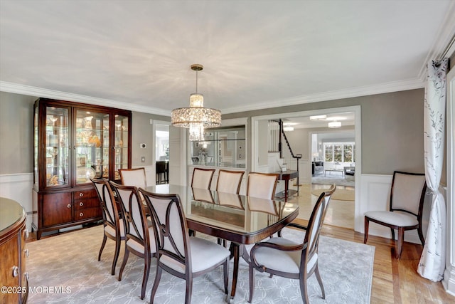 12 Wagon Way, Holmdel, NJ 07733 - dining room with a chandelier, ornamental molding, a wainscoted wall, stairway, and light wood-style flooring