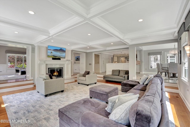 12 Wagon Way, Holmdel, NJ 07733 - living area with wood finished floors, beamed ceiling, crown molding, coffered ceiling, and a premium fireplace