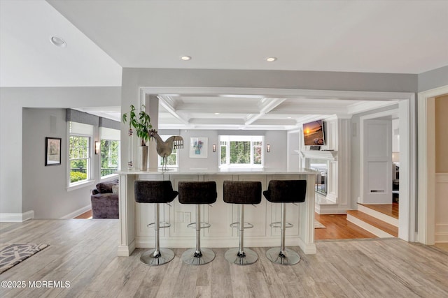 12 Wagon Way, Holmdel, NJ 07733 - kitchen with coffered ceiling, light countertops, a kitchen breakfast bar, light wood-style flooring, and beamed ceiling